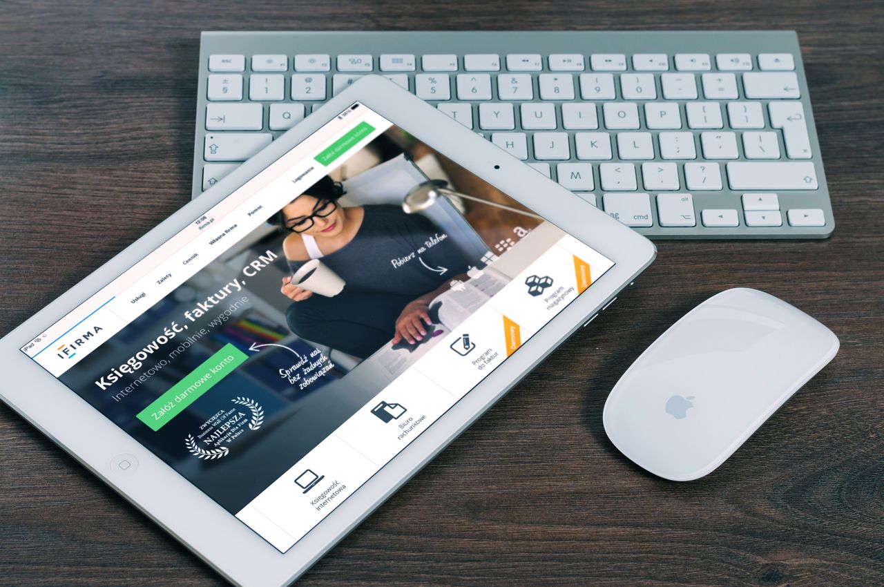 heros-img A tablet with a financial website open, alongside a white keyboard and mouse. Ideal for tech-theme stock images.